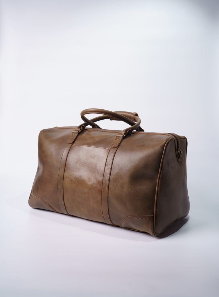 Brown leather travel duffel bag on white background
