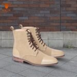 Classic beige cap toe lace up Oxford boots for men on urban background
