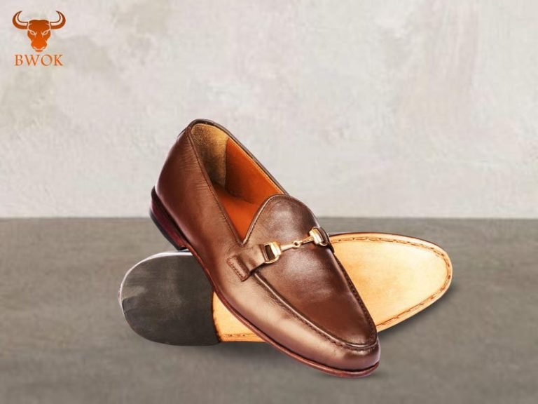 Polished brown men's leather loafers with gold horsebit.