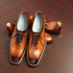 Polished brown leather Oxford dress shoes.