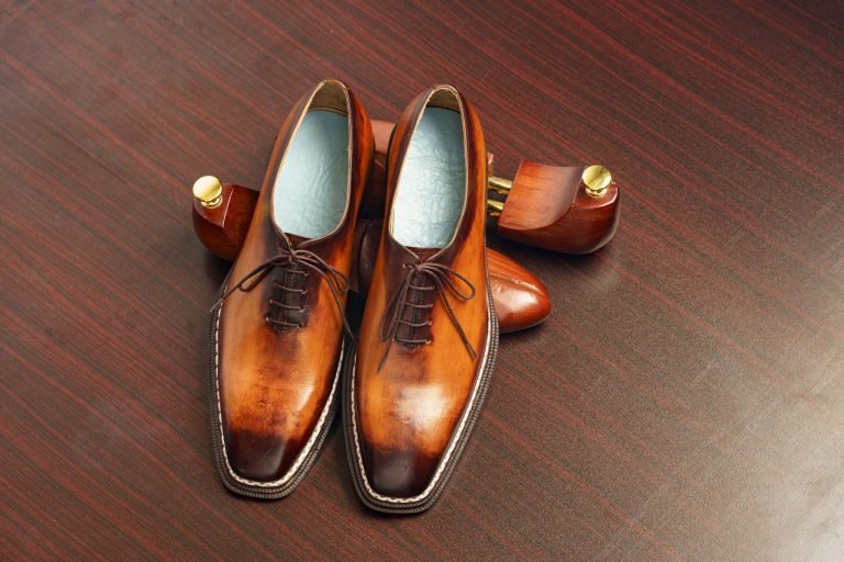 Polished brown leather Oxford dress shoes.