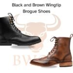 Brown leather wingtip boots with brogue detailing.
