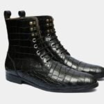 Embossed brown leather lace-up boots with intricate detailing.