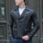 Black leather moto style jacket with asymmetrical zipper.