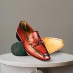 Pair of brown leather tassel loafers shoes.