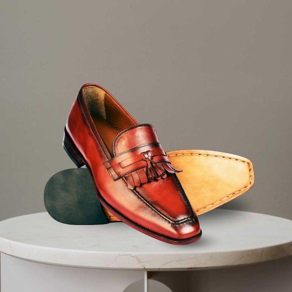 Pair of brown leather tassel loafers shoes.