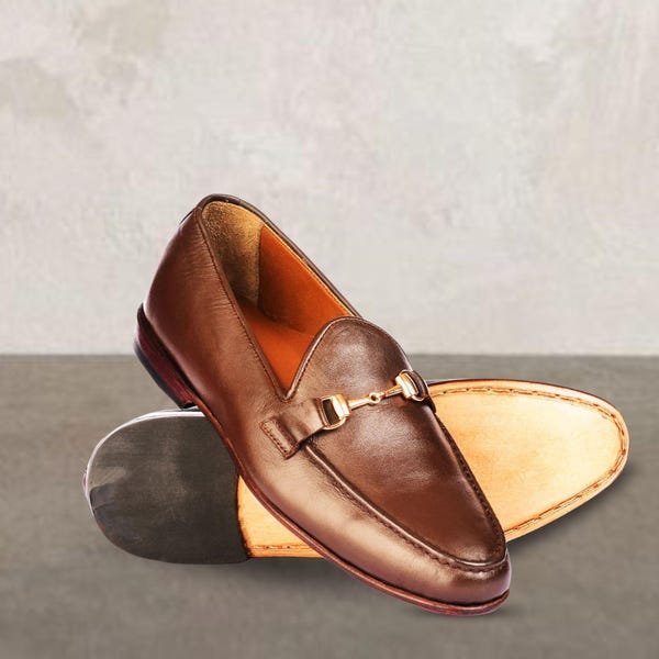 Polished black leather bit loafers shoes with gold horsebit.