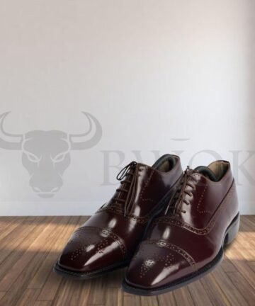 Pair of classic brown leather Oxford shoes on wooden floor - Bwok Store