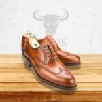 Polished black leather Oxford shoes.