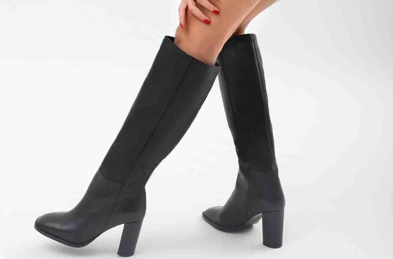 Black long knee-high heeled boots for women with a sleek pointed toe