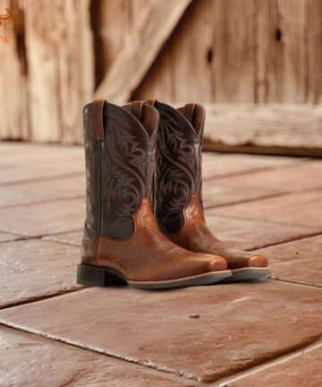 Pair of Western leather cowboy boots on rustic tiled floor - Bwok Store