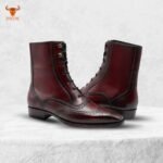 Burgundy leather ankle boots on display with classic stitching