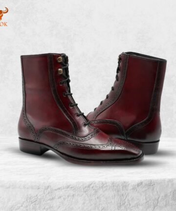 Burgundy leather ankle boots on display with classic stitching